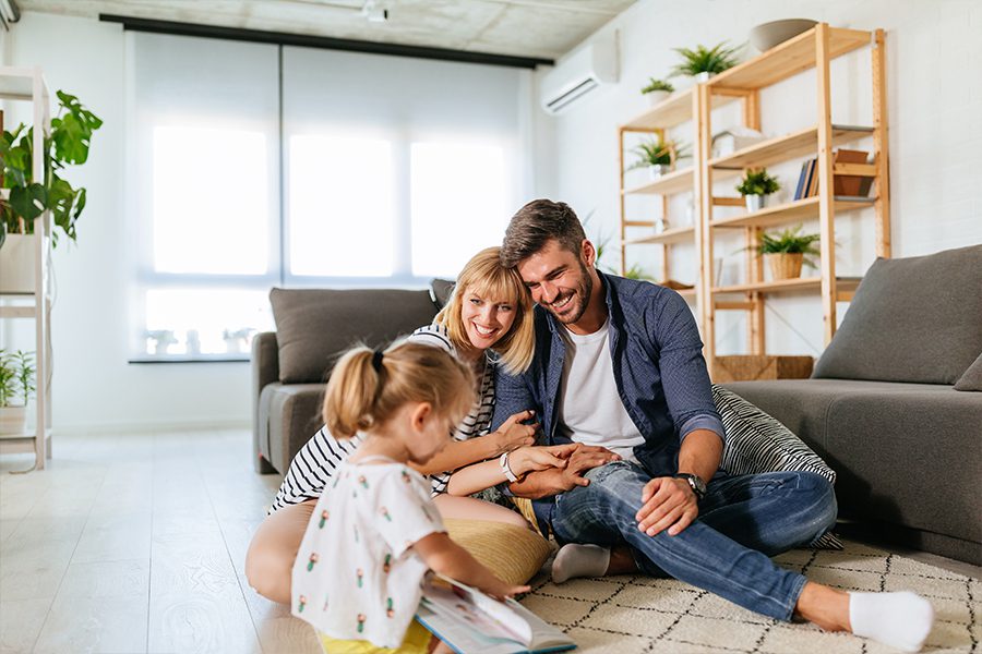 Personal Insurance - Happy Family Enjoying Time Together on the Living Room Floor of Their New Home